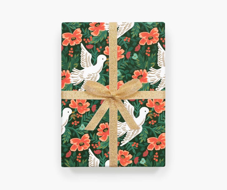 Christmas gift wrap in green and red with illustrations of doves and flowers